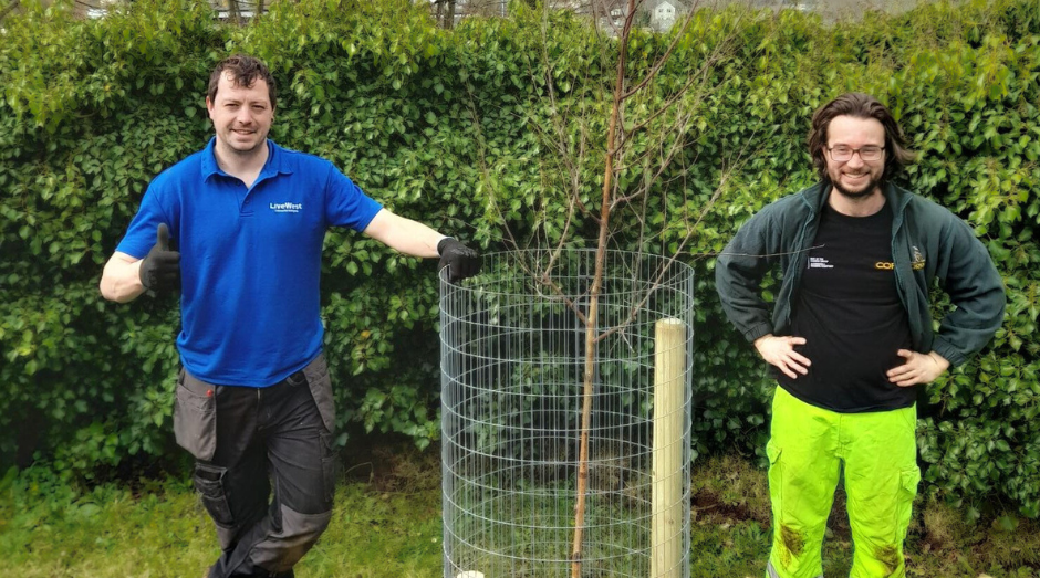 Our Tree Officer on the left smiling with on of our trees.