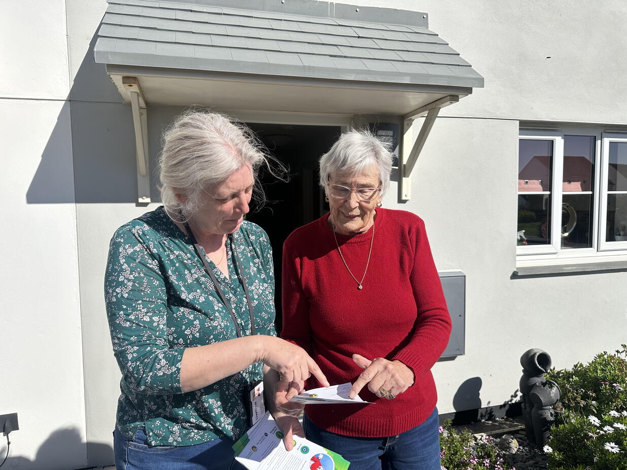 Image of community connector with a LiveWest customer outside her home