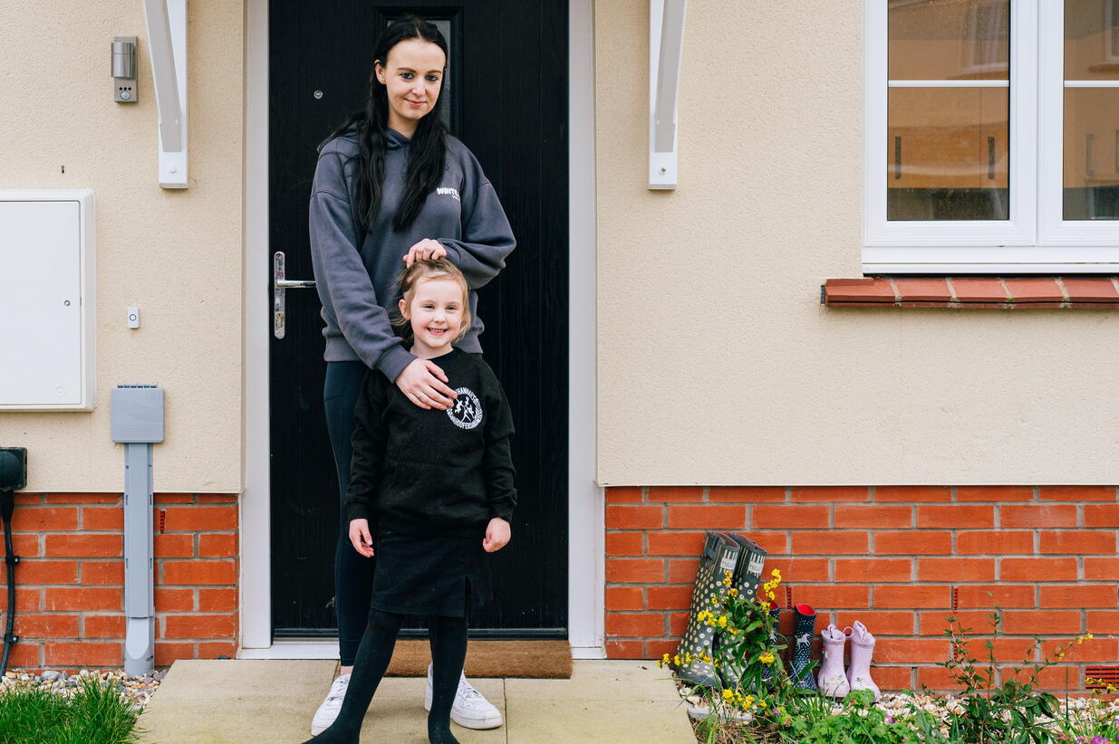 Victoria and her daughter outside their new home.