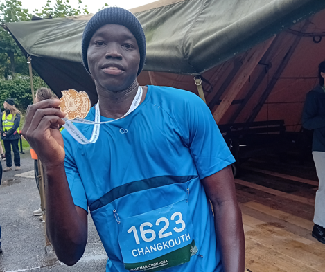 Changkouth with his half marathon medal.