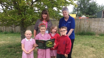 Our colleague Ali Knight presenting the book vouchers to the Headteacher and pupils at Lamerton Primary School.
