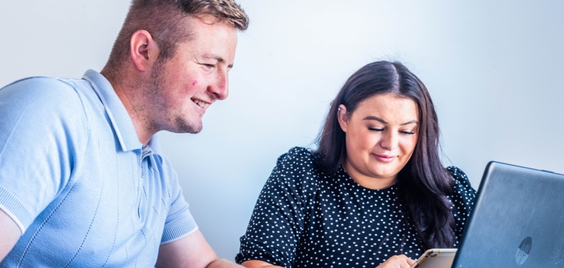 A couple using a laptop. 