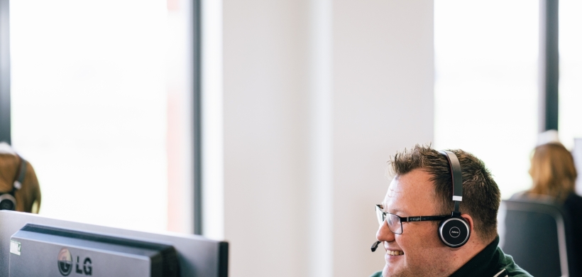 LiveWest colleague talking to a customer using a headset.