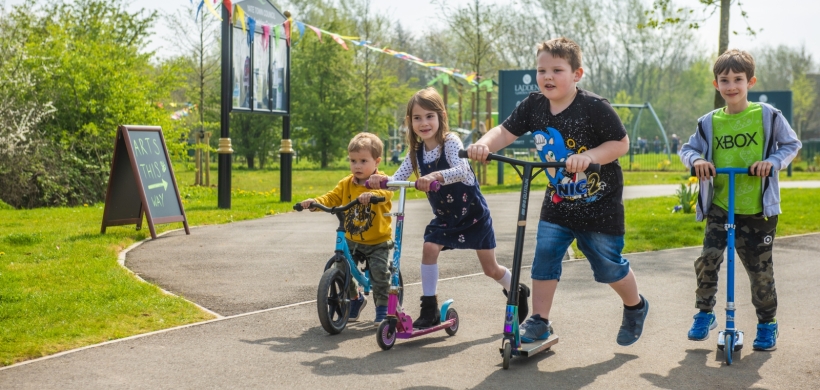 children on bikes and scooters