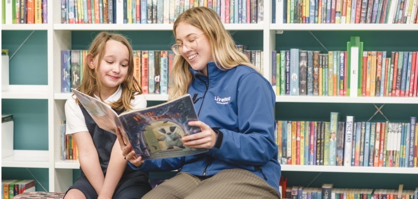 colleague reading book with young resident