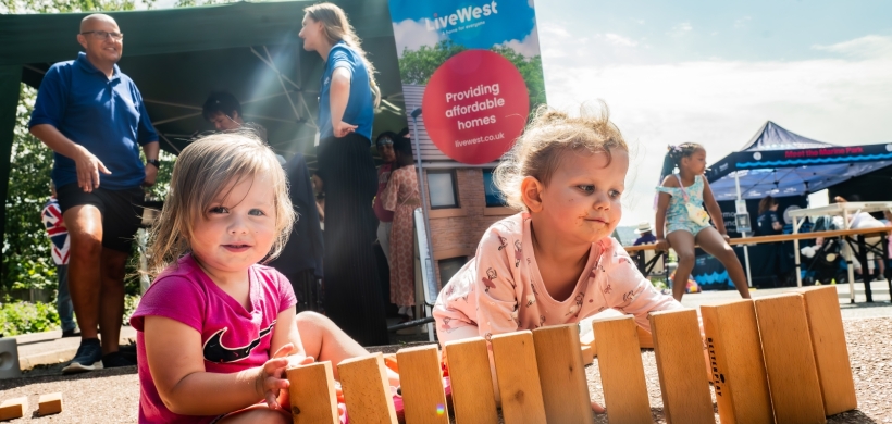 Two girls sat playing with bricks at the fun day.