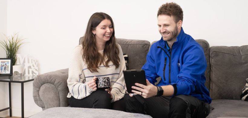 Colleague showing customer new feature on tablet