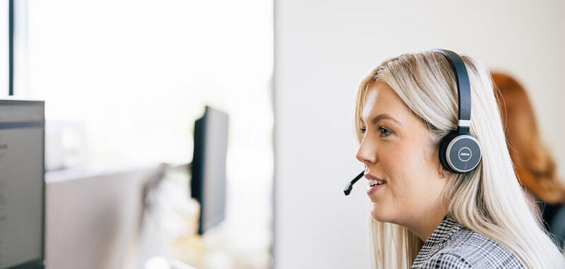 LiveWest Team Member on the phone and looking at computer