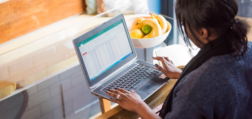 Customer on Laptop looking at spreadsheet