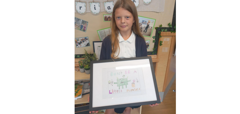 Winner Ella-Rose holding her poster
