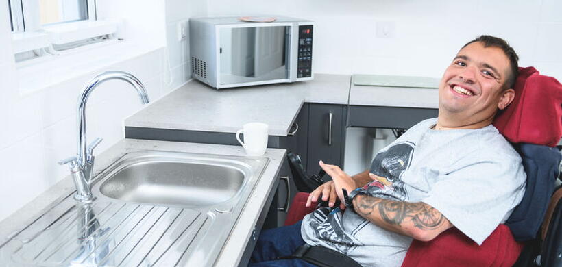 James sat in his wheelchair in his flat.