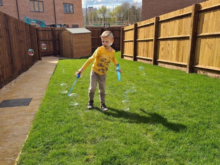 Jaxson playing in his new garden in Hartcliffe