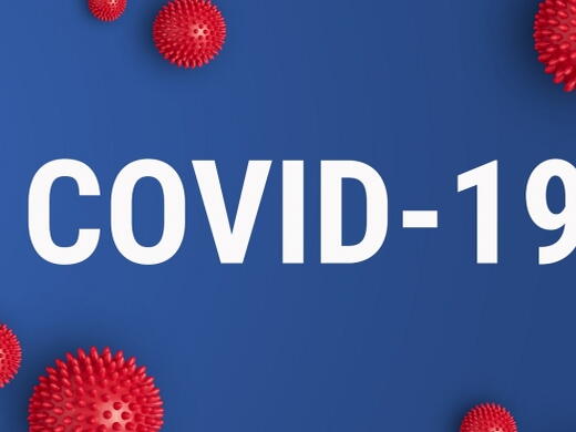 Covid-19 in white lettering on a blue background with red virus particles