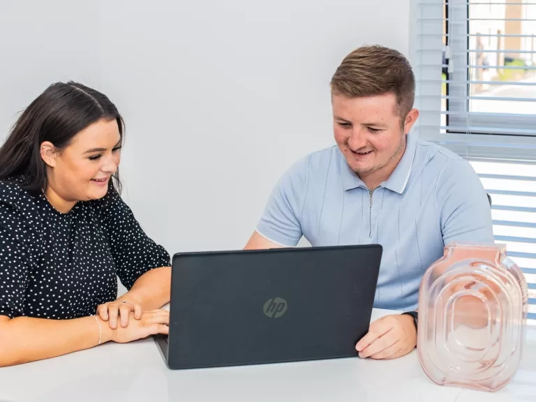 smiling people using a computer