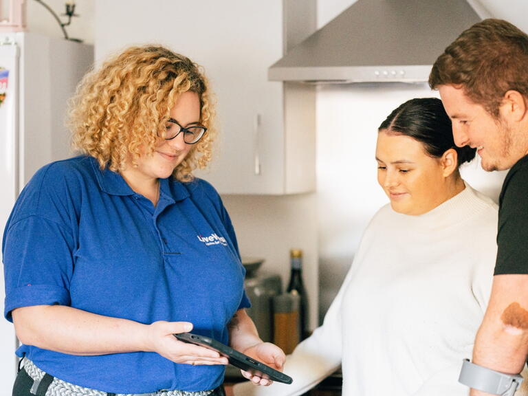 LiveWest colleague talking to two customers in a kitchen
