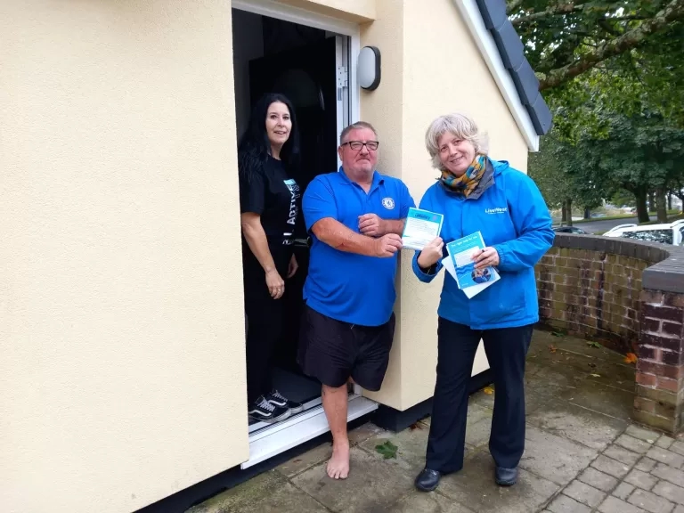 Ali Knight outside a home of two customers.