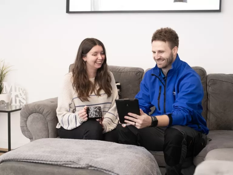 Colleague showing customer new feature on tablet