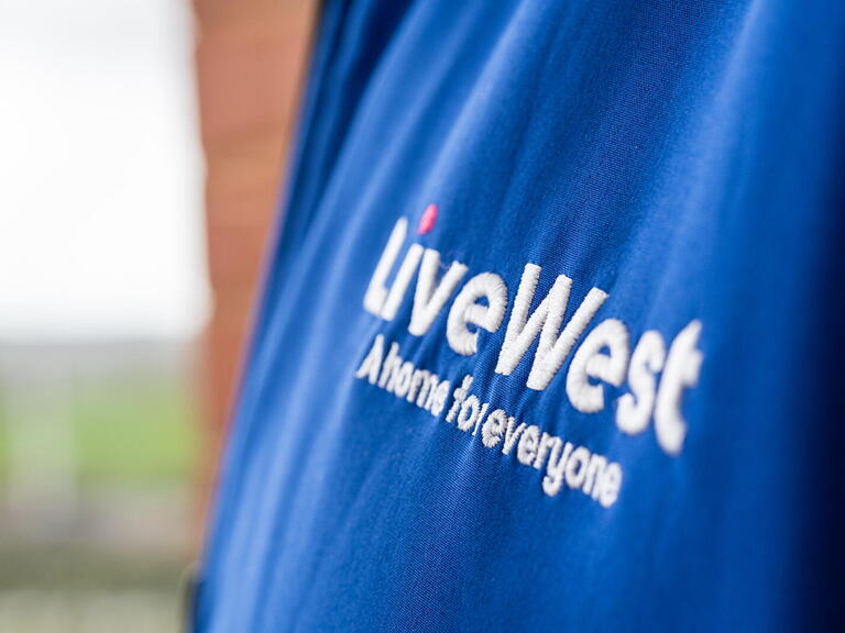 Image of a LiveWest logo on a blue jacket.