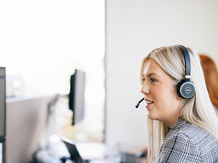 LiveWest Team Member on the phone and looking at computer