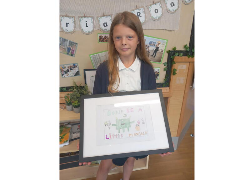 Winner Ella-Rose holding her poster