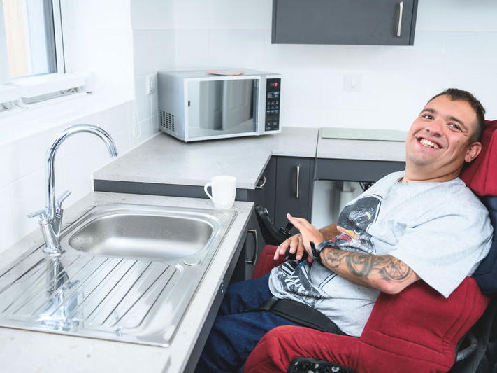 James sat in his wheelchair in his flat.