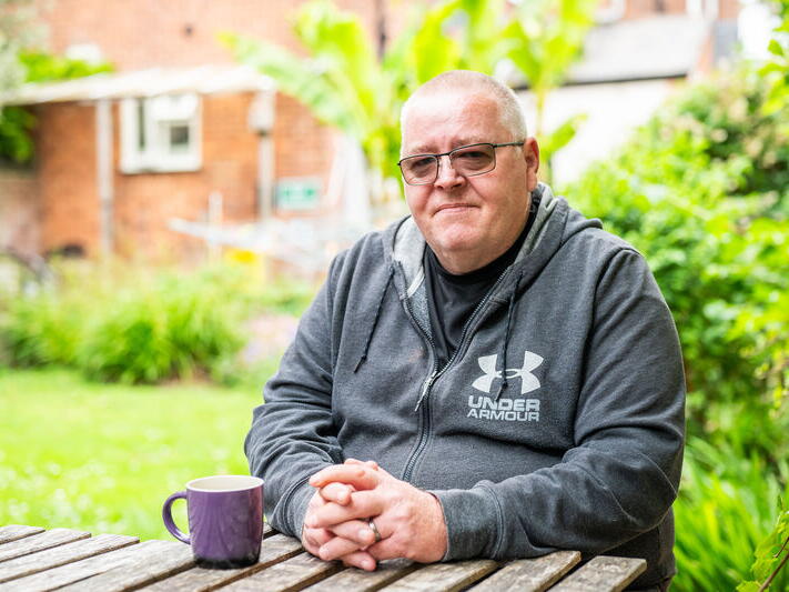 Jason sat at a table in the garden.