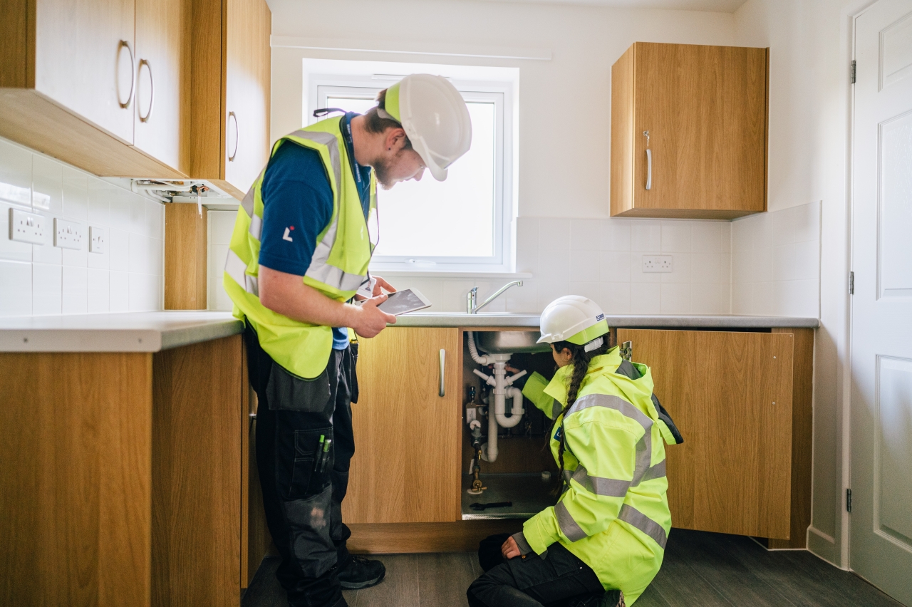 LiveWest colleagues working on a kitchen in a home.