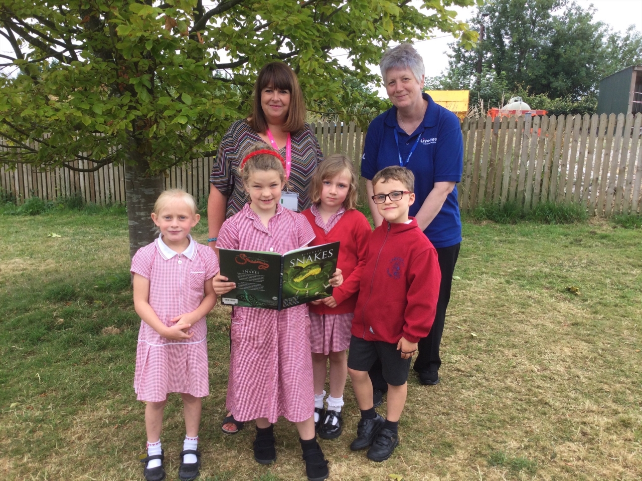 LiveWest colleague with children from school where book tokens were donated.