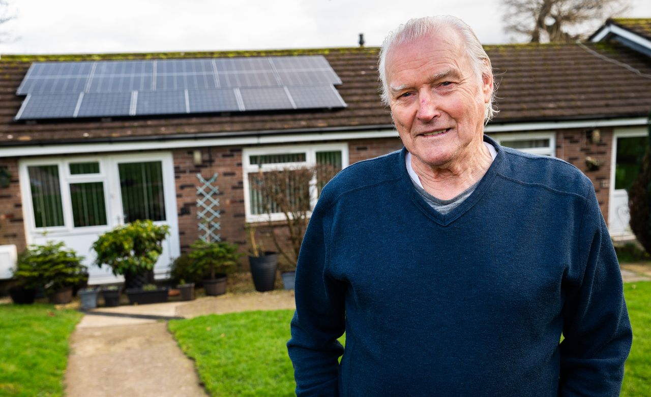 LiveWest resident Patrick outside his home with solar panels on the roof.