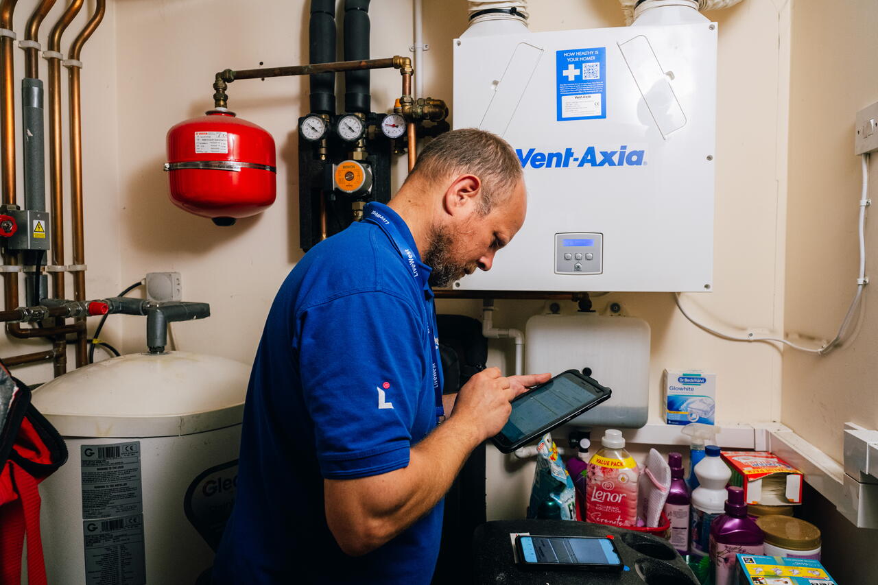 Image of LiveWest colleague working on boiler