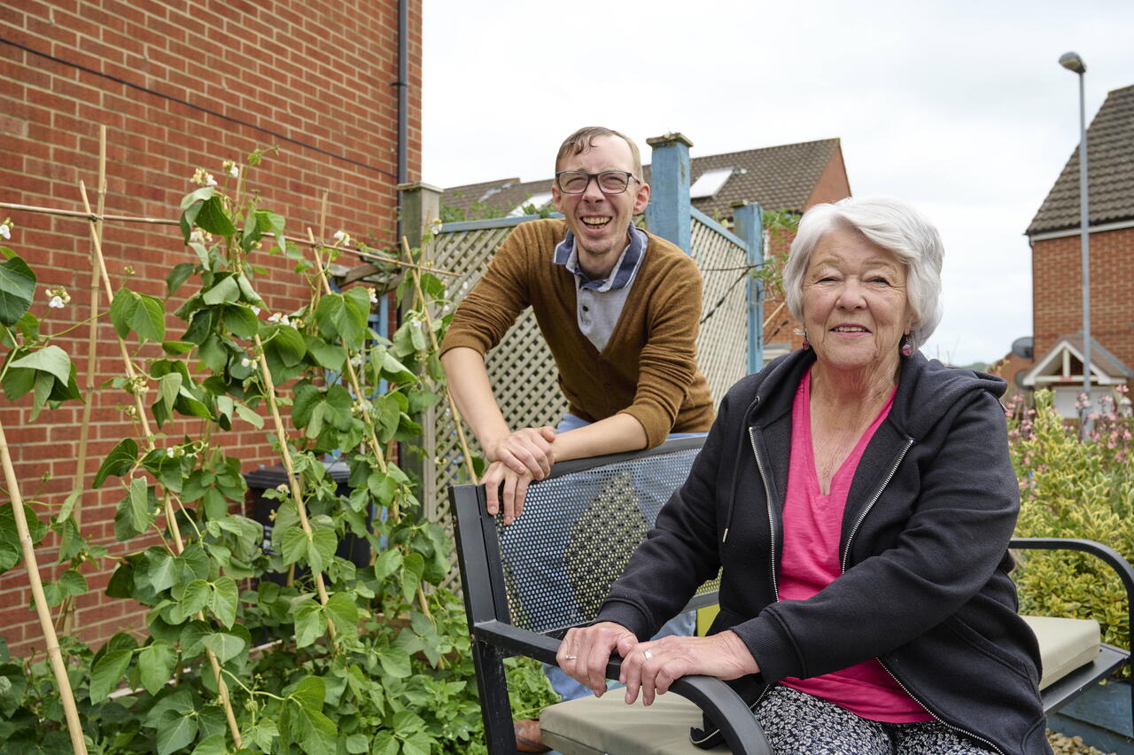 Image of two LiveWest customers smiling in their garden