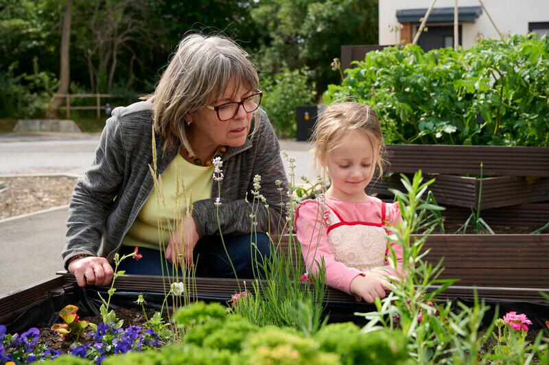 Image of two LiveWest residents looking at their community garden in Sparkford.