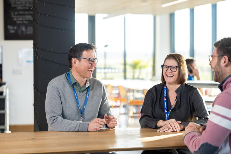 Paul Turner laughing with colleagues