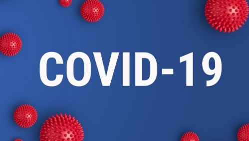 Covid-19 in white lettering on a blue background with red virus particles