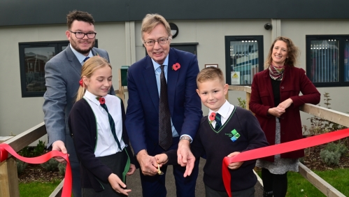 Councillor Dan Brown, Sir Gary Streeter MP, Judy Talbot, Sherford Community Trust Co-ordinator. Front row: Sophia and Harry, pupils at Sherford Vale School.