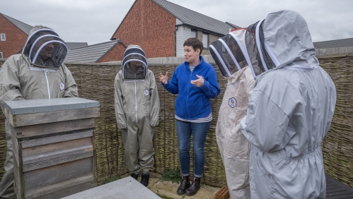 The group of volunteers at Ladden Garden Village by the beehive.