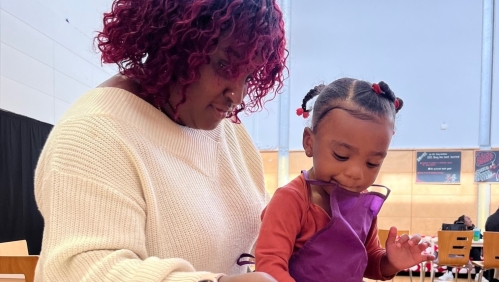 Debbie-Ann at Boing holding her child with cake