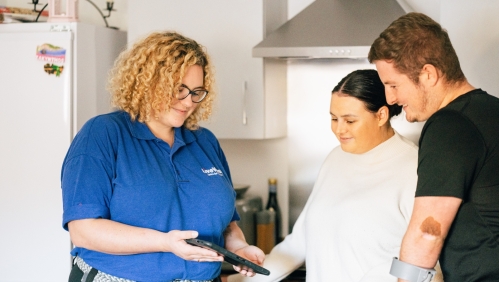 LiveWest colleague talking to two customers in a kitchen