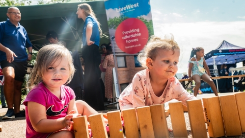 Two girls sat playing with bricks at the fun day.