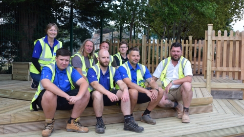 Volunteers sat and stood on the decking they have put in.