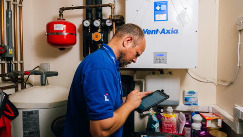 Image of LiveWest colleague working on boiler